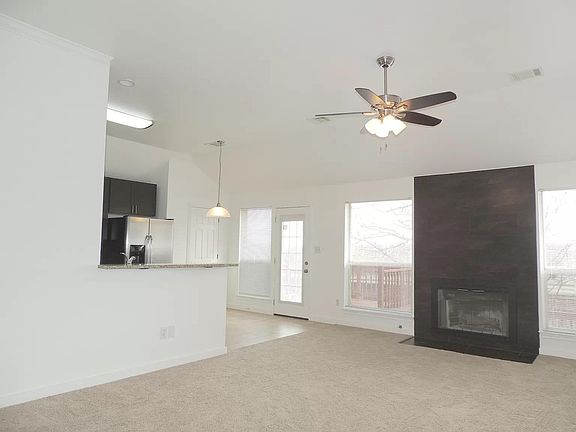 Living room, open kitchen, breakfast nook, walk out to deck.