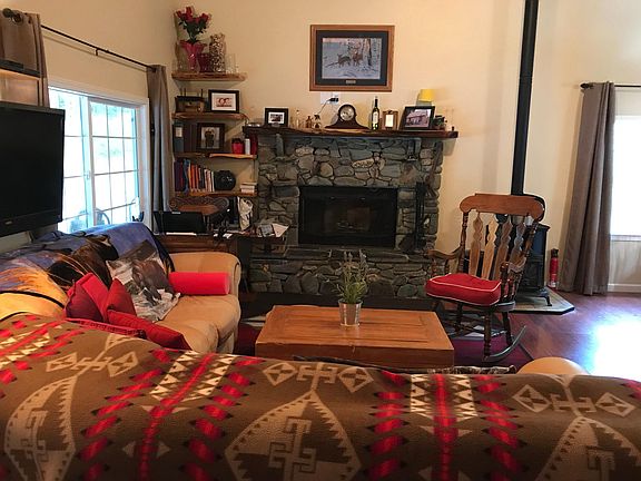 Wonderfully cozy living room with wood burning fireplace. Also has a free standing oil heater which will heat the entire home