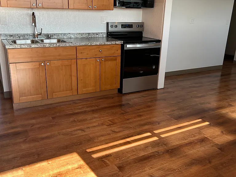 Kitchen with bamboo soft close drawer, electric range and full size refrigerator