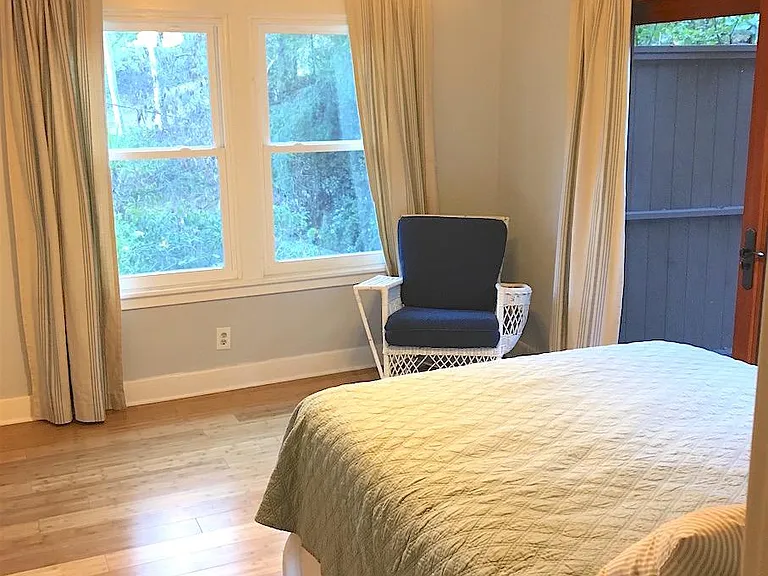 One of two bedrooms that open up to wooden deck