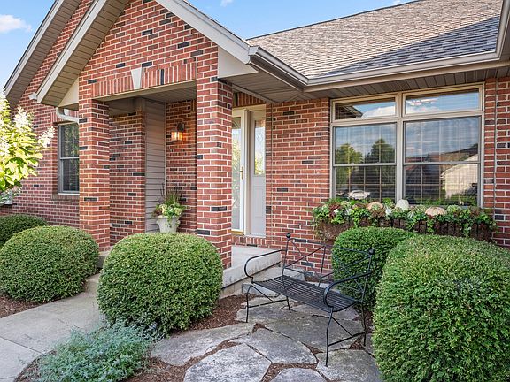 Covered front porch and courtyard to welcome your family and friends! The flower boxes are an added 