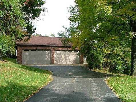 Detached 50' x 30' four vehicle garage includes workshop area and attic storage.
