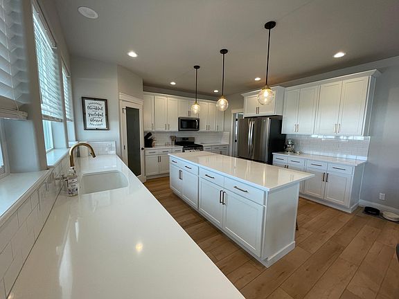 Quartz counters. White cabinets. Gas range. Walk in pantry.