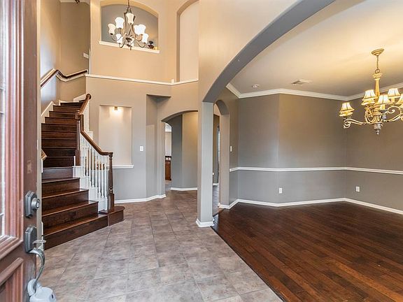 Soaring entryway with nooks to display artwork throughout the home.