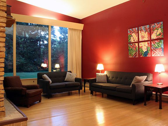 The living room has vaulted ceilings with picture windows facing the backyard.