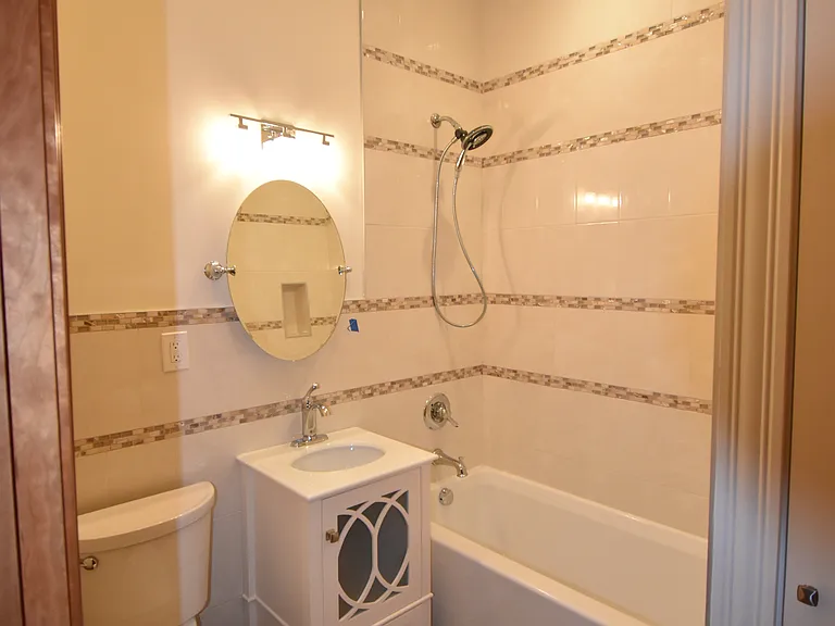 Partial Bathroom View - deep Jacuzzi tub, linen closet, heated porcelain tiled floors