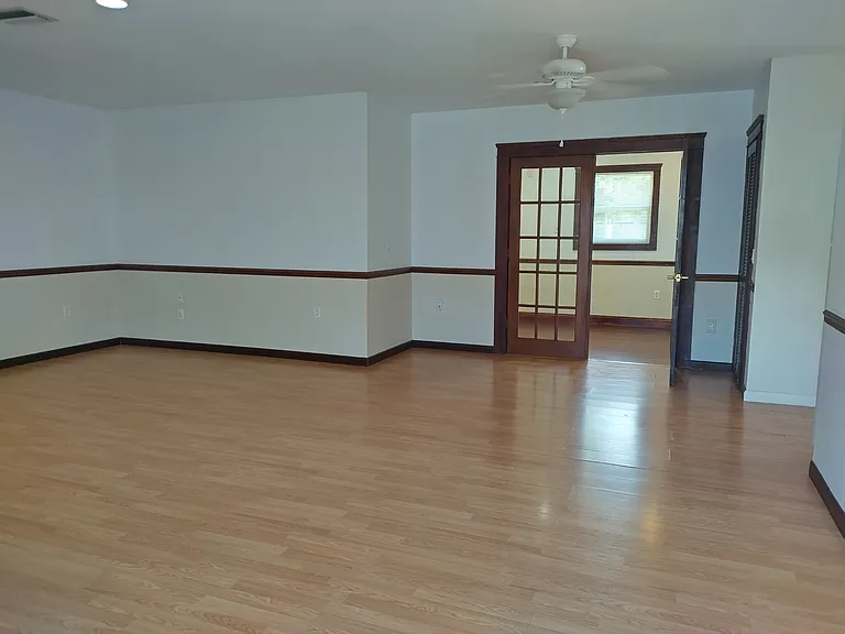 Living area looking into the main bedroom.
