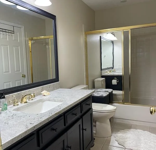 Upstairs shared bath, with doors to larger bedroom and hall