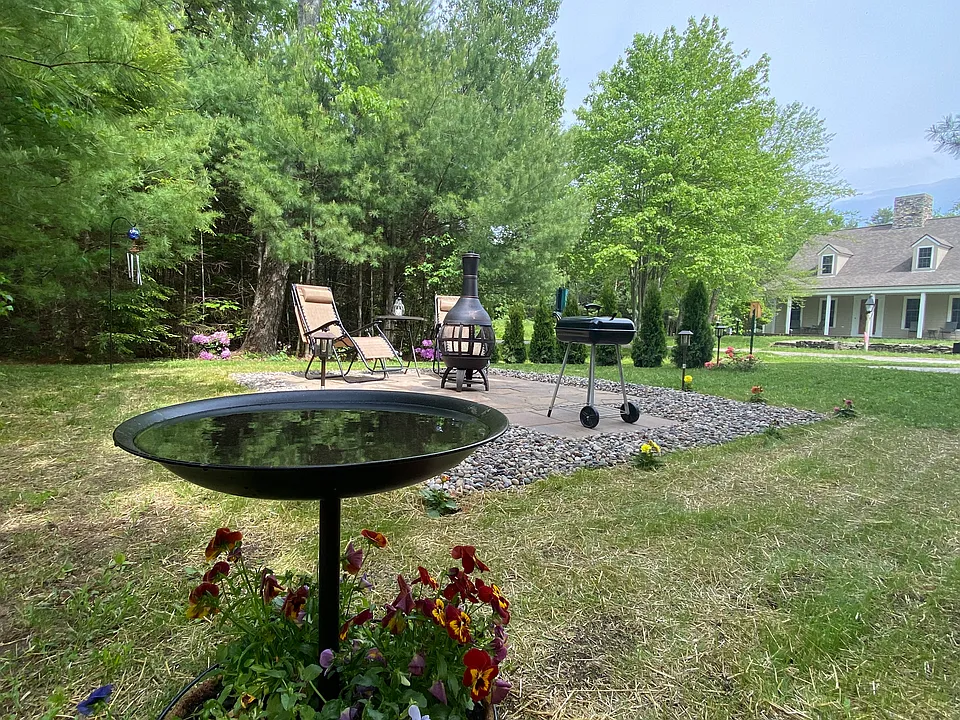 Private patio with space for a grill, fire pit, table and chairs.