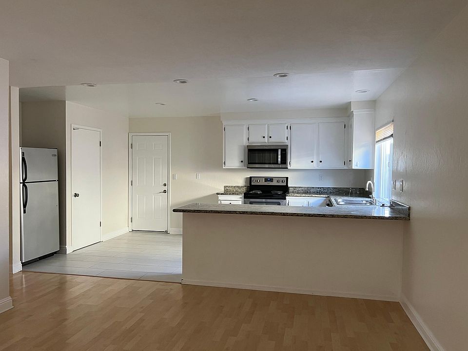 Kitchen with granite counter top, Electric stove, refrigerator, microwave and dishwasher washer. New tile floors.