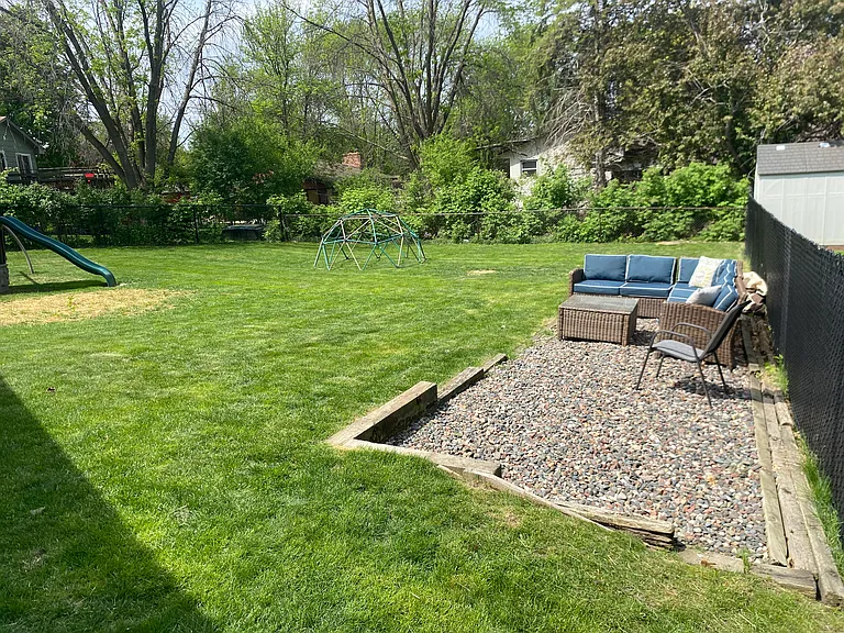 Backyard with lounge area. Plenty of space for kids to play.