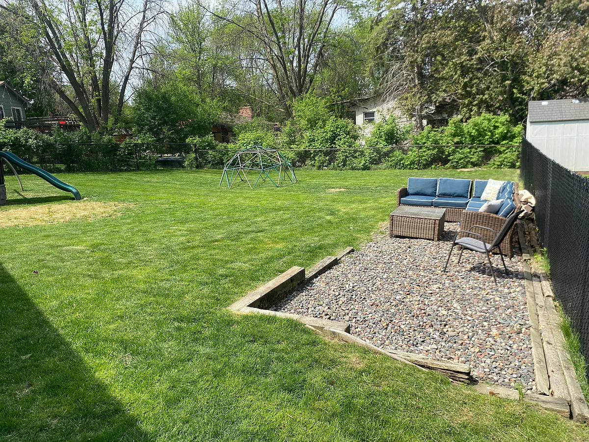 Backyard with lounge area. Plenty of space for kids to play. - 305 Circle Ln SE