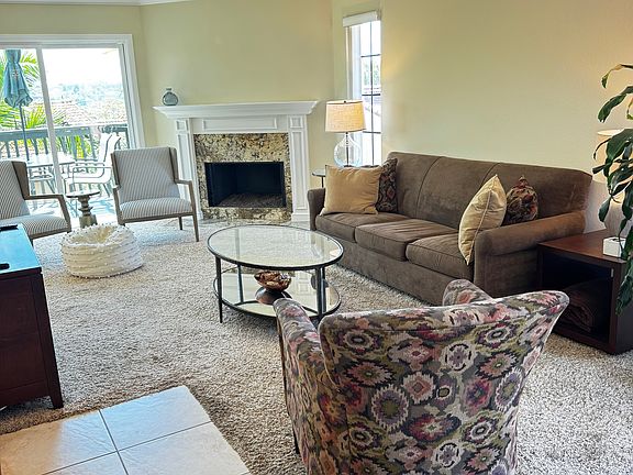 Living room. This is a bright room with west facing windows along the living room. Sliding doors to the upper deck.