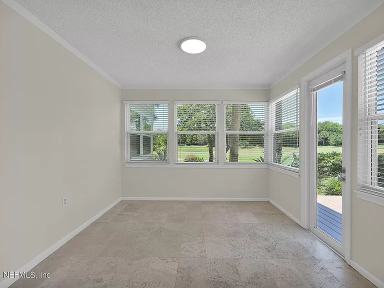Patio enclosed having AC leading out to deck, back yard, views back yard and golf course