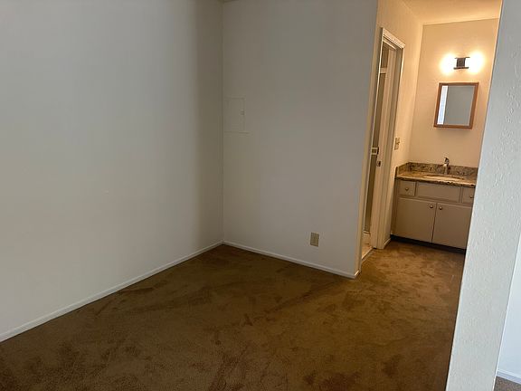 bedroom area has a small wall which provides privacy to other living areas in the studio apartment