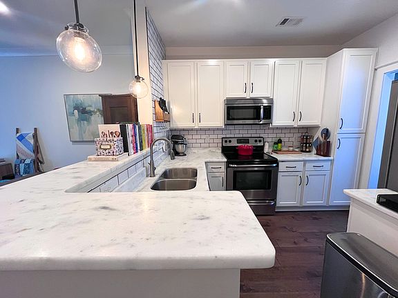 Beautiful kitchen with quartz countertops, subway tile backsplash, and stainless steel appliances.