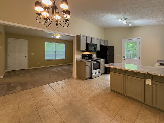 Kitchen with Side Entrance and Dining Area into Living Room