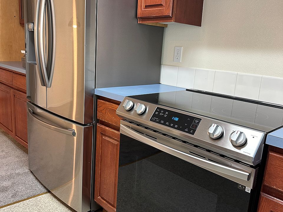 New stove, vent and refrigerator (as well as dishwasher) in kitchen