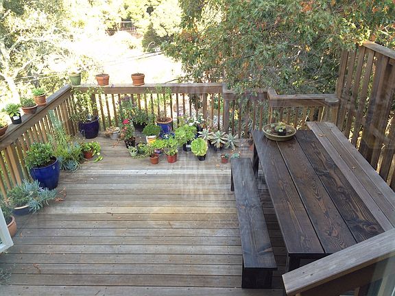 Dining deck off the living room has a treehouse feel.