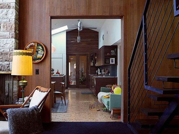 View into kitchen/dining room from living room. Two natural 