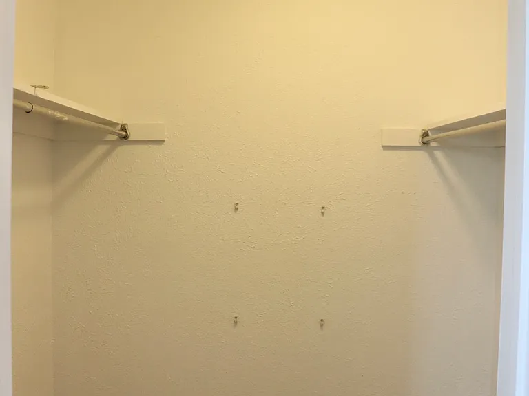 Primary bedroom walk-in closet.