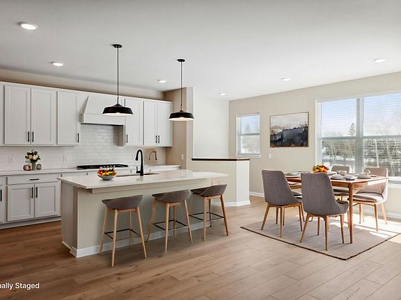 The kitchen flows seamlessly into the bright and sunny dining room.