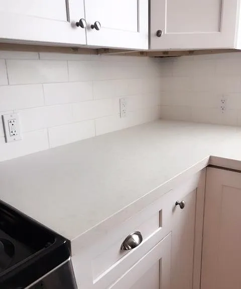 Quartz countertop and soft-close cabinets in the kitchen.