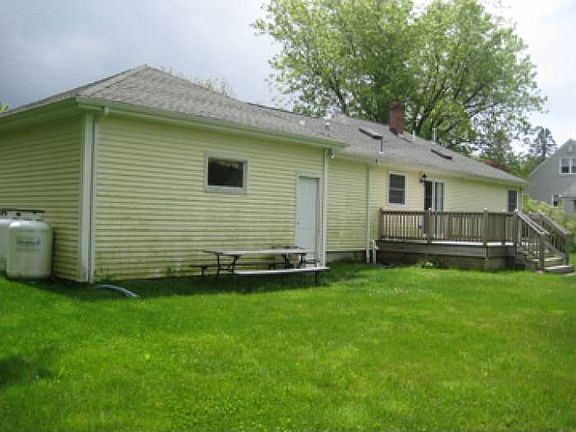 back of house with deck
