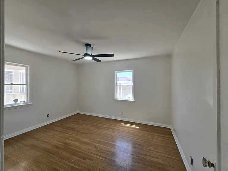 BACK BEDROOM IS APPROXIMATELY 13'.5" X 11'.6"