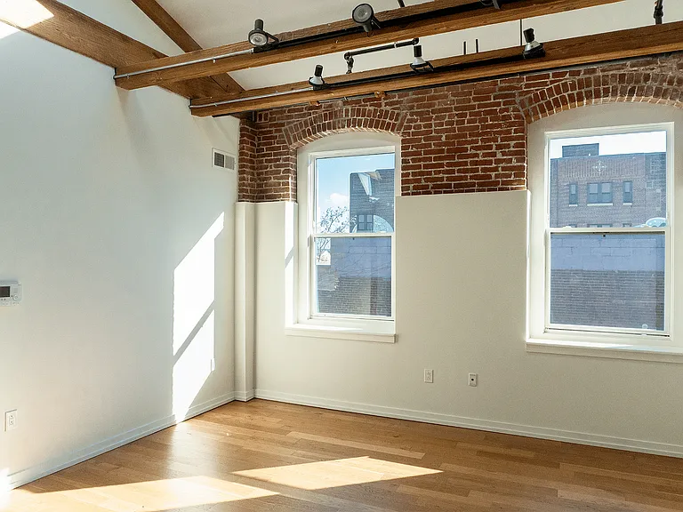 Experience the charm of a sunlit loft blending modernity with rustic elegance.