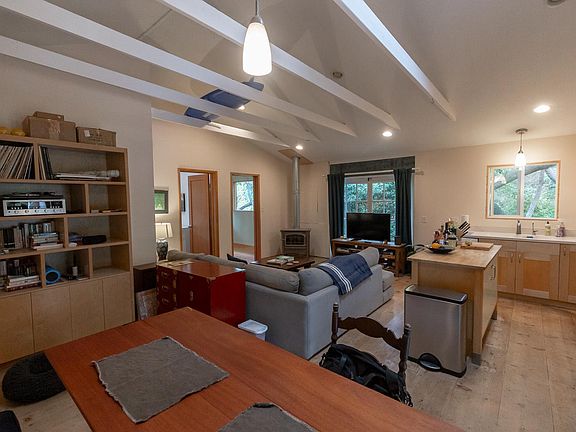 View from sitting on the bench with living room directly ahead and kitchen space on the right