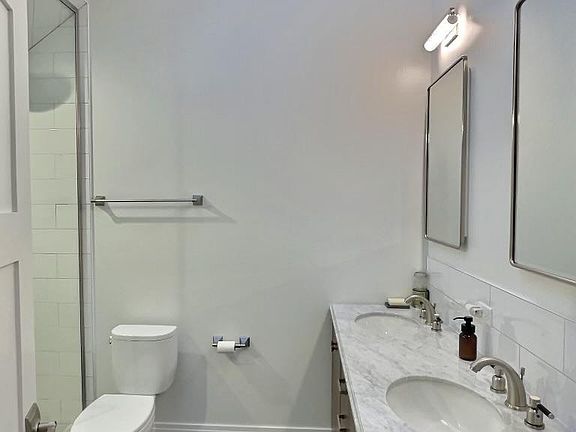Heated floors, double vanity. Natural stone counters.