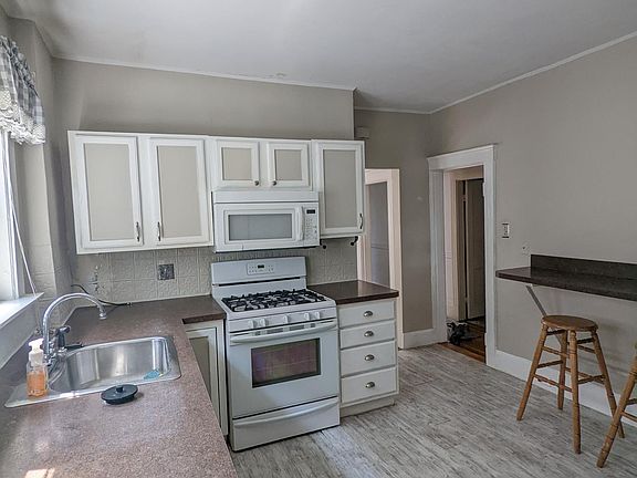 Kitchen with refrigerator, gas top, dishwasher, microwave, and the high-top seating available. Plenty of cabinets and storage space