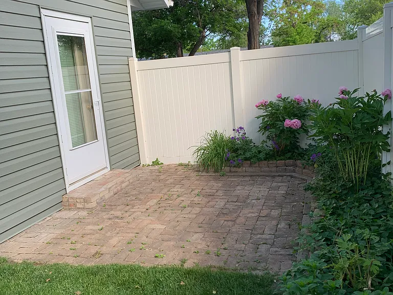 Brick planter includes perennials such as: Peonies, lilies, bleeding heart and irises