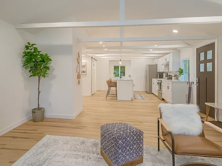 Bright, open-concept layout connects the living room seamlessly to the fully equipped kitchen_perfect for cooking, entertaining, or just relaxing at home