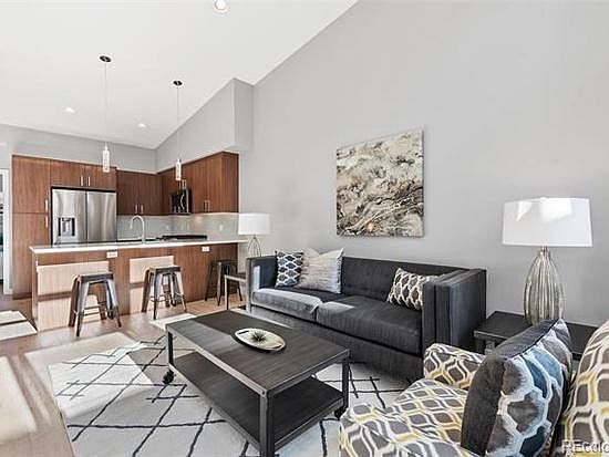 Open living/dining/kitchen with large windows