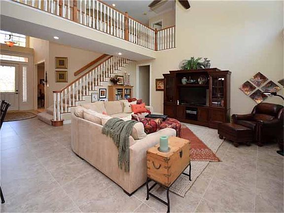 High ceilings and natural light abound in the family room.