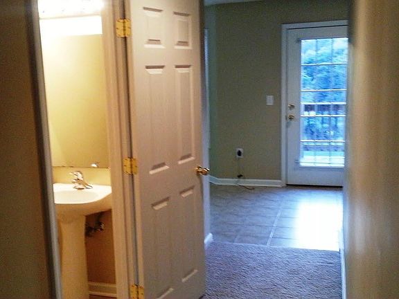 Main floor half-bath and view of front door.
