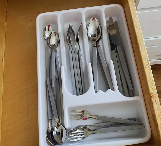 Complete cutlery set including spoons, forks, and knives.
