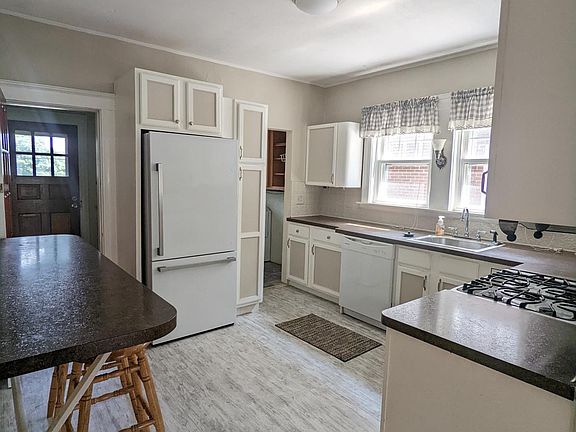 Kitchen with refrigerator, gas top, dishwasher, microwave, and the high-top seating available. Plenty of cabinets and storage space
