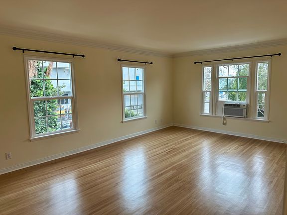 Many windows, an AC window unit, very bright sunlight