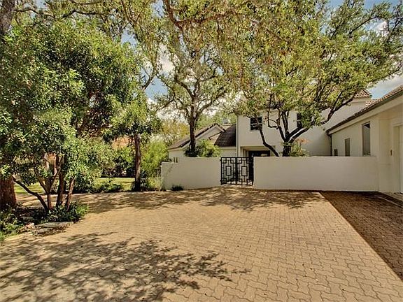 Gated courtyard with stucco exterior.