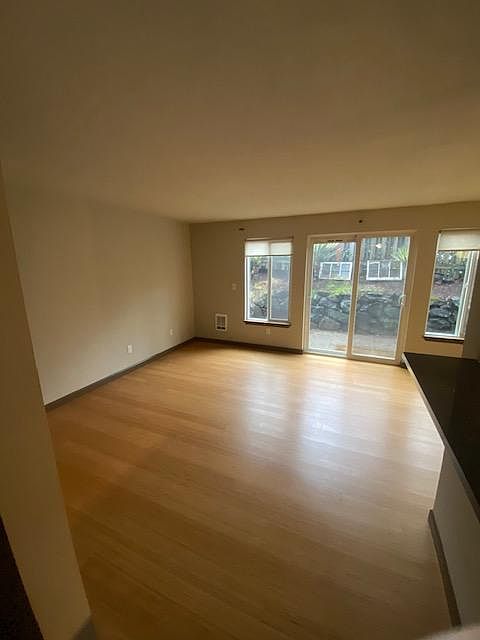 Living room comfortably fits a couch, accent chair, coffee table, and entertainment center.