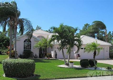 Front view of home with 3 car garage. Pavered drive and sidewalk.