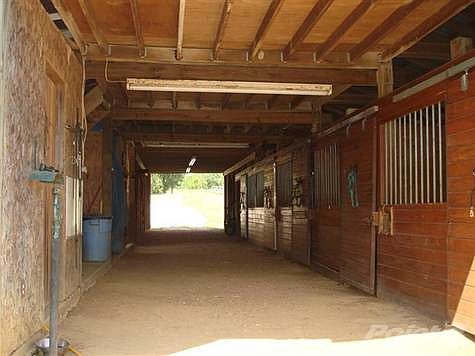 Interior of 70' x 36' 5 Stall Barn with Tack Room, Grain Room, Hay Loft and Storgage Area.