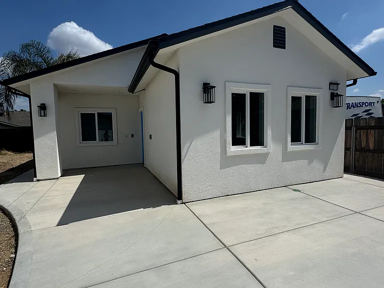 Front view of home with new 3' cement pathway around home and
wide driveway for medium length vehicles.