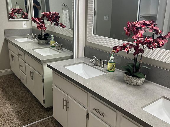 Better view of renovated sinks next to mirrored sliding closet in 1st bedroom.