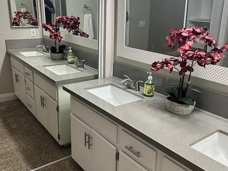 Better view of renovated sinks next to mirrored sliding closet in 1st bedroom.