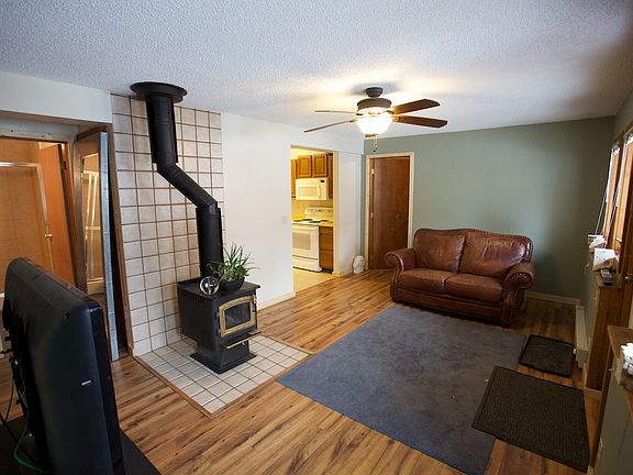 Living room looking toward kitchen and 2nd bedroom. Bathroom can be seen on the left side of the frame.