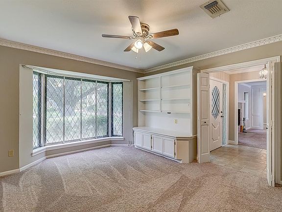 Study off the entry with built-in cabinets and shelves could also double as a game room.
